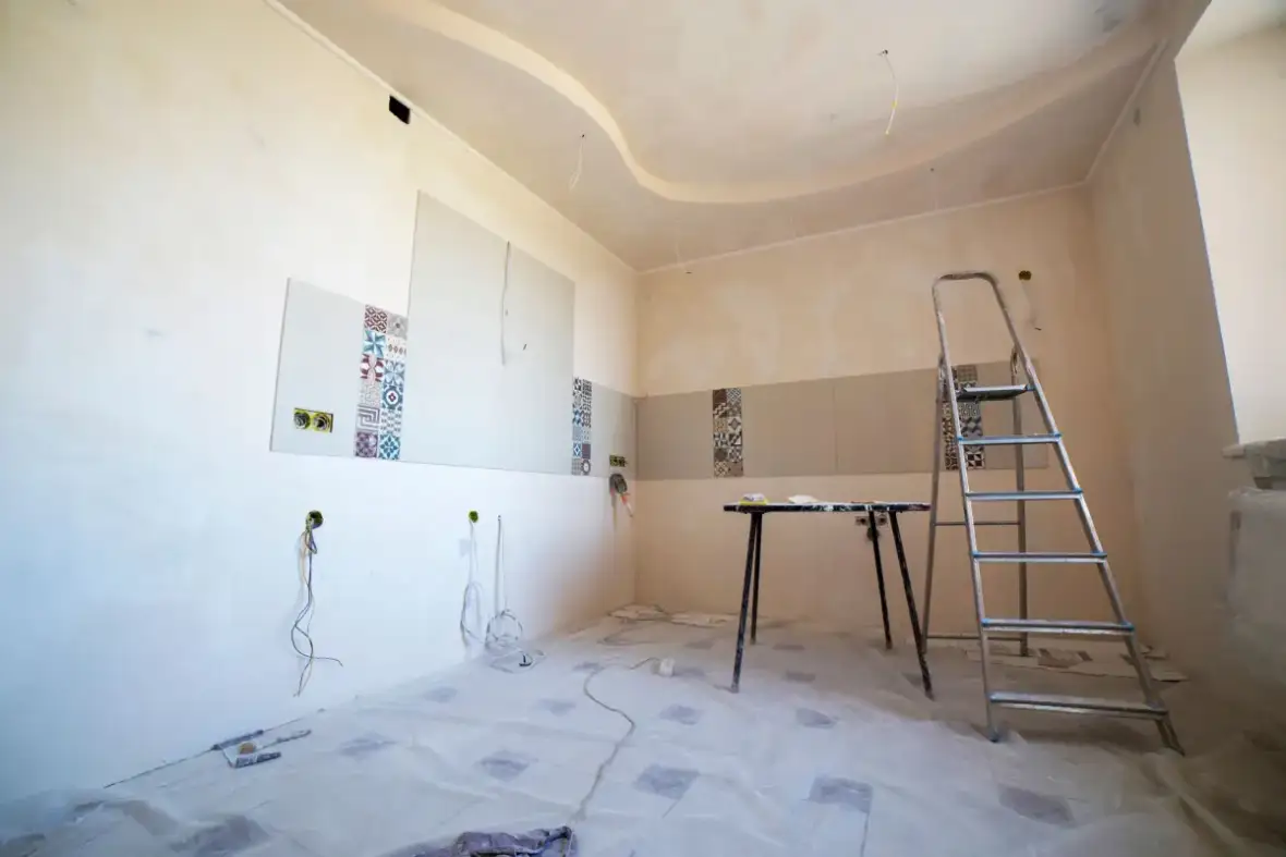 Room set up for ceiling drywall repair with tools and materials in place