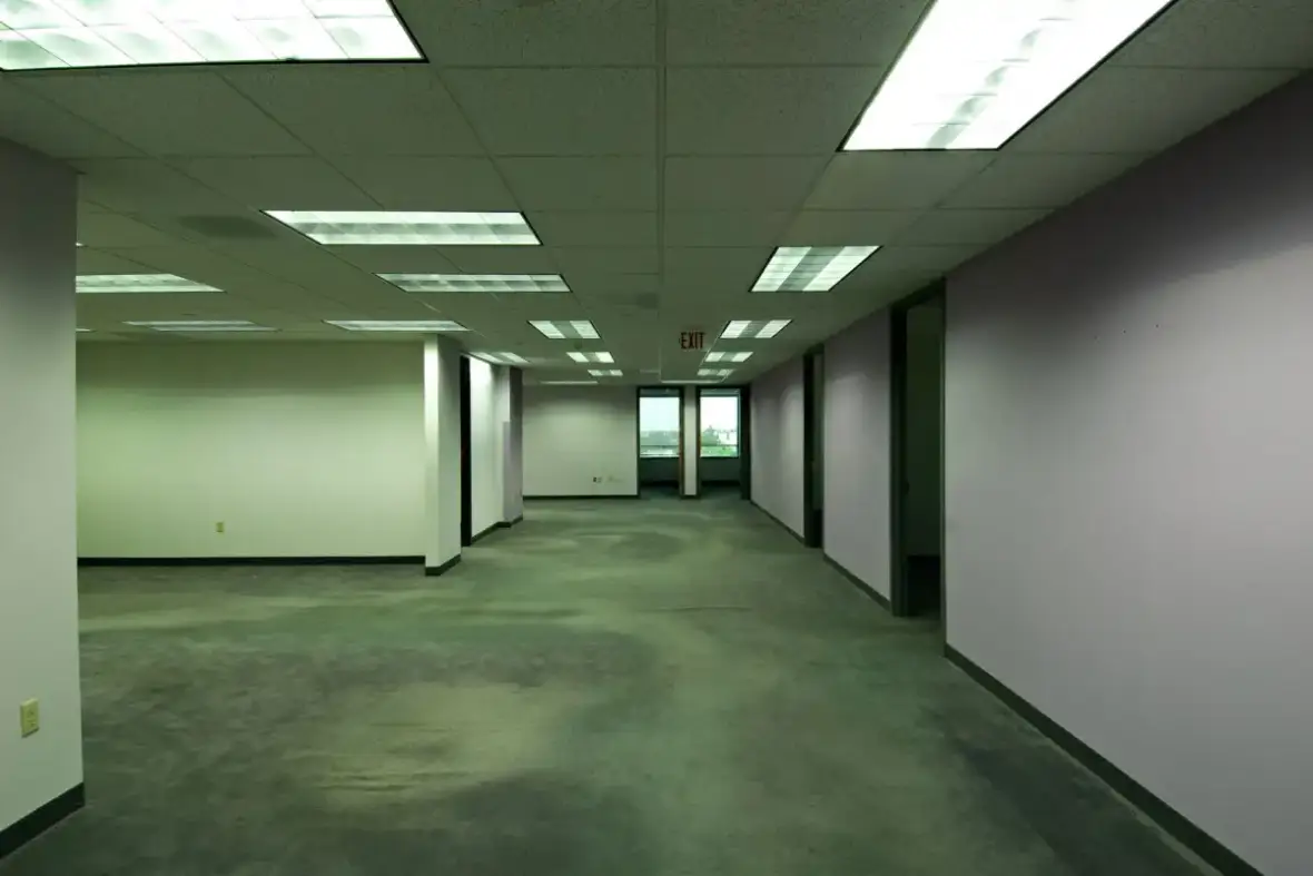 Empty office floor plate with large uninterrupted wall surfaces awaiting finishing