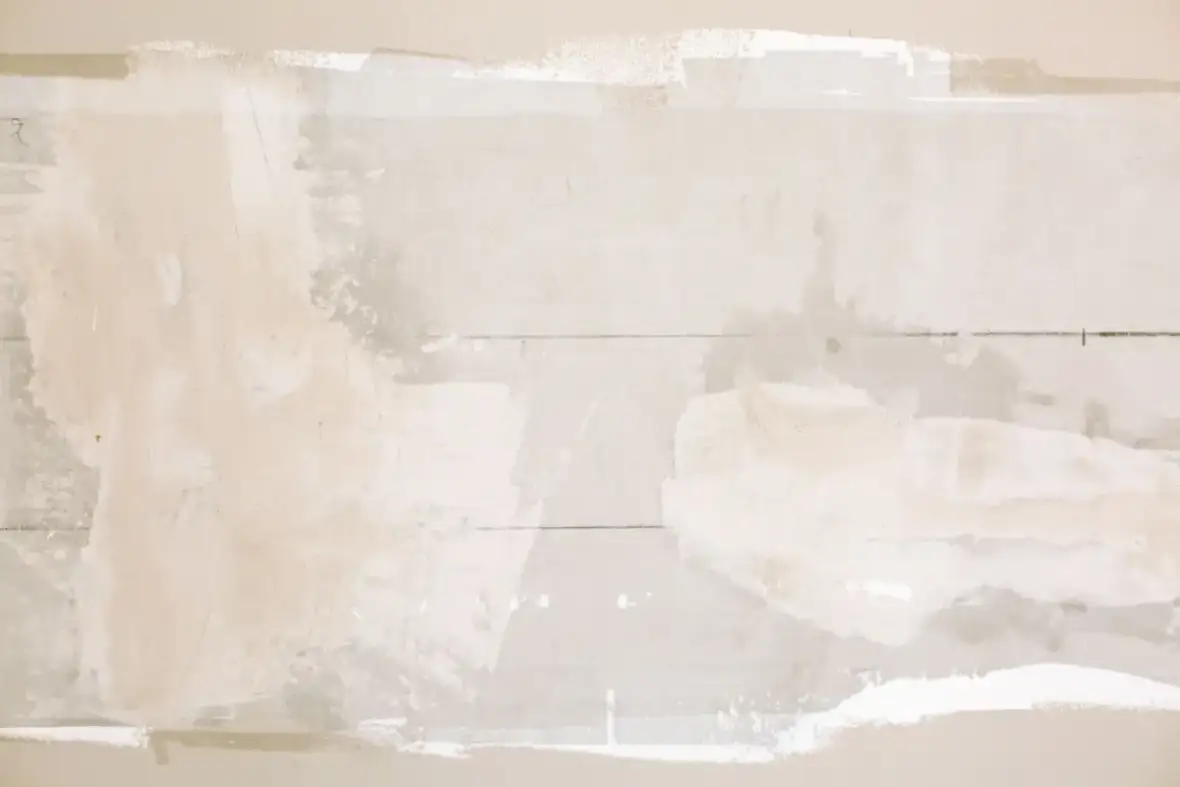 Drywall patch in place before the surrounding texture is matched