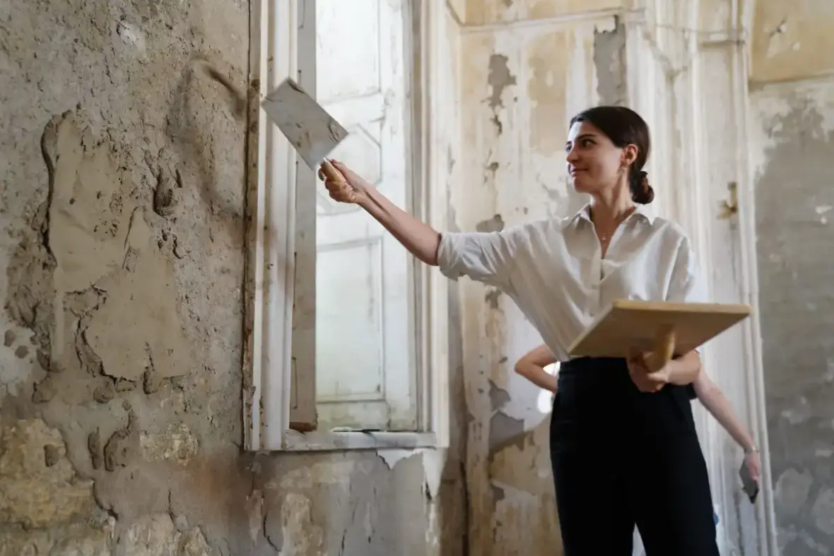 Plaster repair material worked into a damaged section of an older wall